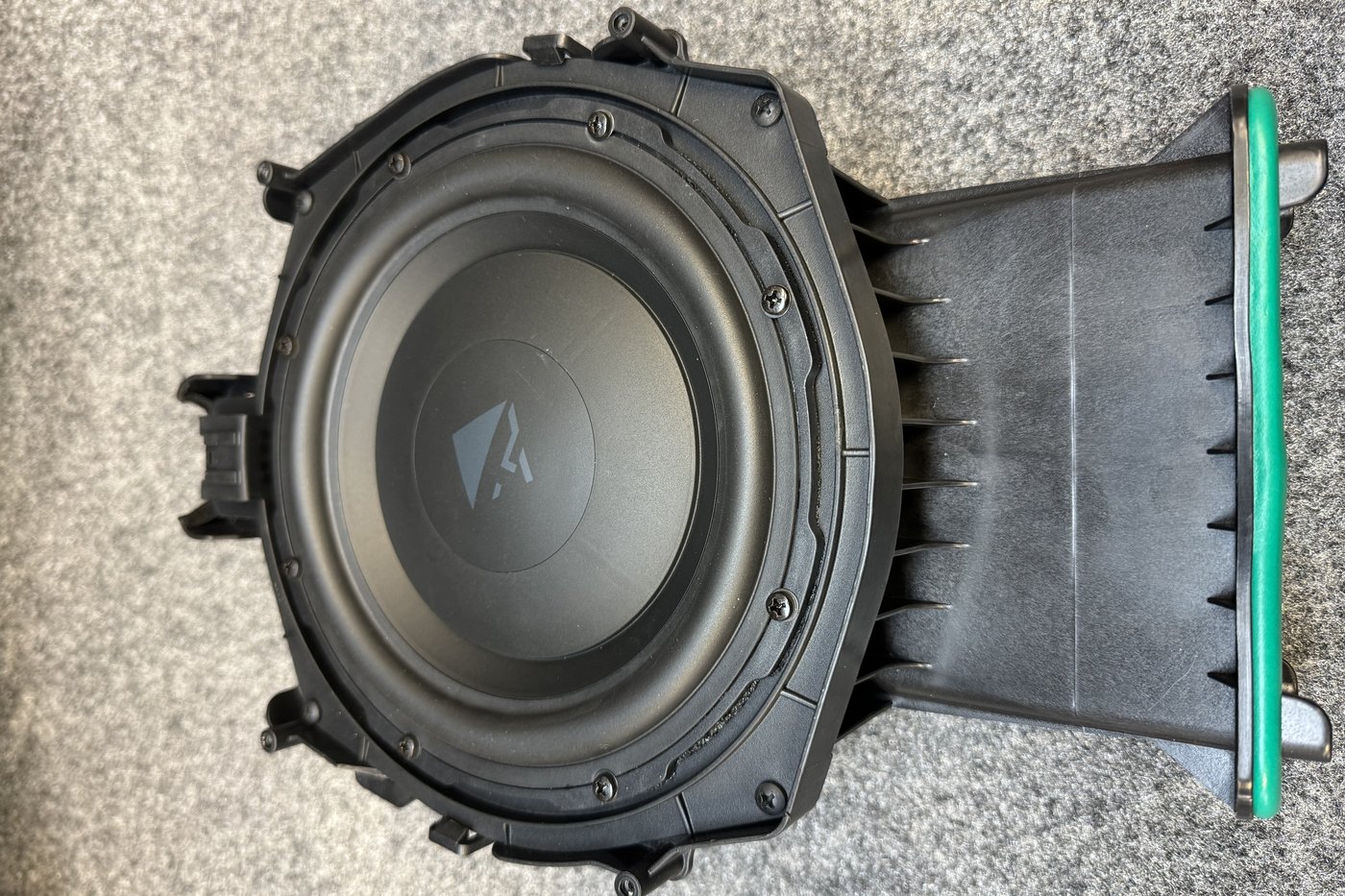 The same BMW enclosure with an upgraded subwoofer fitted in place of the factory driver