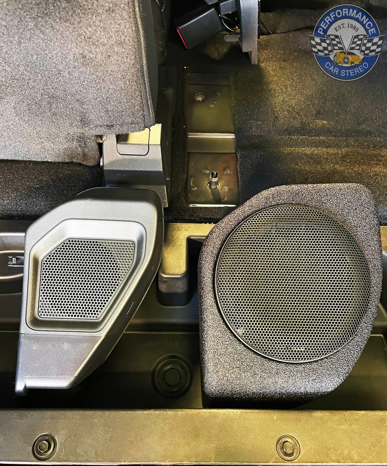 The Bronco's original moulded plastic speaker pod beside the new custom pod built to hold a 6.5-inch speaker