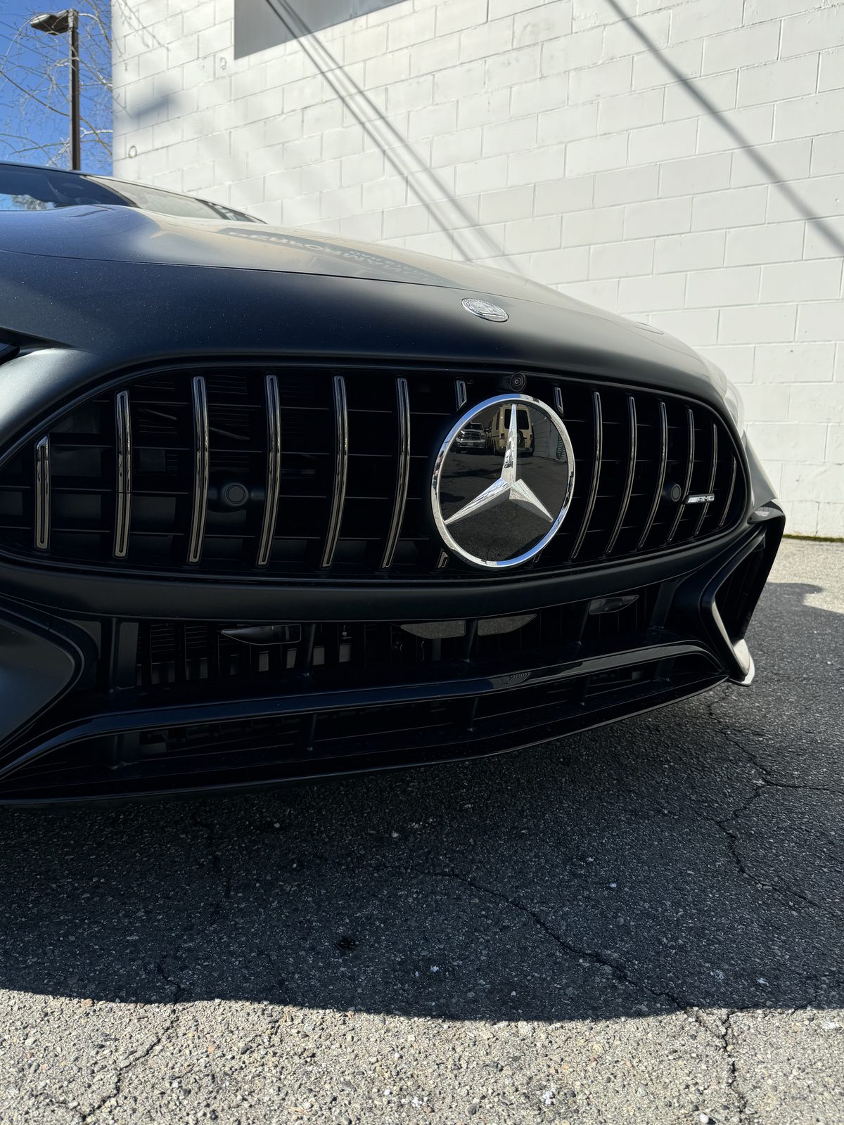 The Panamericana grille of a black Mercedes-AMG SL 63, with the radar system's sensor modules set discreetly between the vertical grille slats