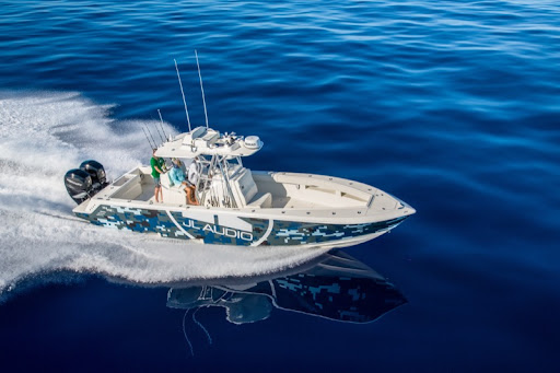 Center-console boat with a marine audio system on open water